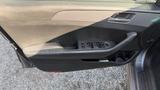 Interior door panel of a 2018 Hyundai Sonata featuring window control buttons and a door handle