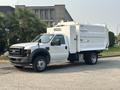 A white 2009 Ford F-550 utility truck with a boxy rear compartment displaying the word HAUL IT