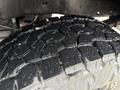 Close-up of a tire tread featuring deep and aggressive patterns on a 2008 Ford F-250 SD showcasing its rugged design and grip