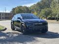 A 2023 Fisker Ocean, a sleek black electric SUV with a modern design, featuring distinctive headlights and a bold front grille