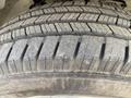 Close-up of a tire tread pattern on a 2023 GMC Savana showing deep grooves and textured surface for traction