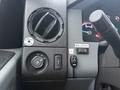 Dashboard controls of a 2015 Ford F-450 featuring air vents a knob for headlights and buttons for parking brake and bin locks
