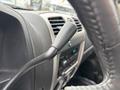 Close-up of the gear shift lever in a 2011 Chevrolet Colorado interior showcasing the control features and design elements of the vehicle