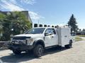 A 2017 Ford F-550 truck with a white exterior and a utility body designed for service work with tools and equipment storage compartments