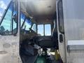 Interior view of a 2009 Workhorse W62 showing the driver's seat and dashboard with visible controls and a green gas cylinder on the floor