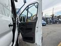 A 2020 Ford Transit 250 van with an open side door revealing the interior features and seating area