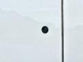 A close-up view of the rearview camera on a white 2016 RAM 1500 truck