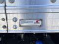 A metal identification plate featuring the logo and information for Supreme Corporation on a 2022 Isuzu NRR truck