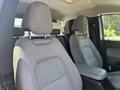 Interior view of a 2017 Chevrolet Colorado showing two front seats with grey upholstery and a center console in between