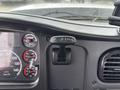 The interior dashboard of a 2013 Freightliner 114SD featuring a lever labeled TR with gauges displaying speed and engine metrics