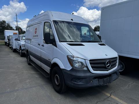 A 2016 Mercedes-Benz Sprinter van with a white exterior parked among other vehicles