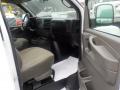 Interior of a 2011 Chevrolet Express with a driver’s seat and dashboard visible featuring a steering wheel gear shift and control panel