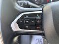 Close-up of the steering wheel control panel of a 2022 RAM Promaster 350 featuring buttons for phone calls navigation and settings