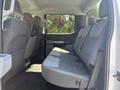 Interior view of the back seat of a 2023 Ford F-350 SD with gray upholstery and spacious seating area