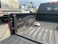 A 2015 RAM 1500 truck bed with a dirty surface and a gray cloth placed inside it