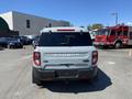 2023 Ford Bronco Sport viewed from the rear with a gray exterior and distinctive badging on the tailgate