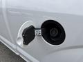 Close-up of the fuel door on a 2018 Ford F-150 showing the cap and fuel filler with instructions for refueling
