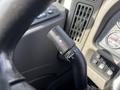 Close-up of the turn signal lever in a 2013 International WorkStar featuring a black handle with symbols for turn signals and windshield wipers