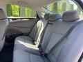 2015 Hyundai Sonata back seat featuring two headrests and seatbelts with a light gray fabric interior