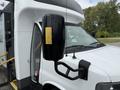 A 2020 Chevrolet Express with a side mirror featuring a yellow indicator light