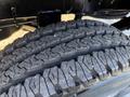 Close-up of a thick, rugged tire tread on a 2023 RAM 3500 showing deep grooves designed for traction and durability