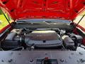 A red 2018 GMC Canyon with the hood open revealing a V6 engine and various engine components visible