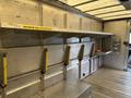 2012 Ford E-450 Super Duty with a spacious cargo area featuring metal shelving and hooks for securing items