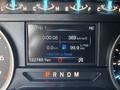 Dashboard display of a 2019 Ford F-150 showing trip information including time distance to empty fuel economy and total kilometers driven