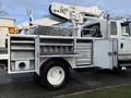 A 2013 International Durastar 4300 truck featuring a utility body with multiple storage compartments and an elevated aerial lift mechanism
