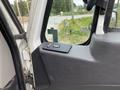 Interior view of a 2014 International Durastar door panel featuring a control switch for window operation and a textured black handle