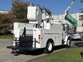 A white 2005 Freightliner M2 106 bucket truck featuring a rear-mounted work platform and various tools and compartments on the side