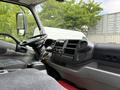 Interior view of a 2018 Hino 195 featuring a steering wheel dashboard with controls and seats in a gray fabric