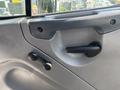 Interior door panel of a 2019 Freightliner M2 106 featuring a door handle and window crank mechanism