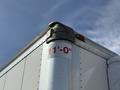 A close-up of the corner of a 2023 Ford E-450 with a height measurement of 11-0 marked in red on the side of the vehicle