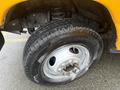 Close-up of a tire on a 2021 Ford Econoline with visible treads and a silver rim showcasing five lug bolts