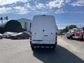 A 2010 Mercedes-Benz Sprinter van viewed from the rear with a white exterior and a simple design