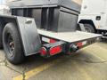 A 2005 Katolight SED60FPJ4 generator with a black metal frame and a diamond plate surface featuring red and white reflective tape and round tail lights