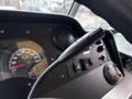 Close-up of the dashboard of a 2018 Ford Econoline showing the speedometer, control knobs, and gear shift lever