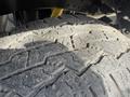 Close-up of a worn tire from a 2011 Ford F-350 SD showing cracked tread patterns and dirt accumulation on the surface