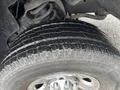 Close-up of a tire on a 2006 Dodge Ram 2500 showing detailed tread patterns and shiny chrome wheel rim