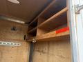 Interior of a 2016 Continental cargo trailer featuring wooden shelves and a metal hook on the side