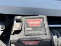 Close-up of a Warn M8 contactor control switch mounted on a 2017 Chevrolet Colorado showcasing the brand logo and control interface