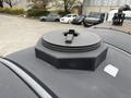 Close-up of a round black fuel tank cap on the top of a 2016 Peterbilt 348 truck with a hexagonal design and a central lever for opening