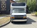 A 2020 Chevrolet Express with a large white box-shaped body and a silver front grille facing the camera