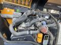 A detailed view of the engine compartment of a 2013 JCB 510-56 Loadall featuring various hoses and components in a compact layout