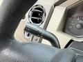 Close-up of a 2008 Ford F-250 SD steering column showing the windshield wiper control lever and part of the dashboard with a speedometer
