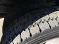 A close-up of a tire from a 2009 Ford F-550 showing its tread pattern and surface texture