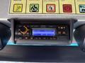 A 2012 Ford Econoline dashboard featuring a radio with digital display and control buttons