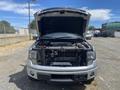 A 2014 Ford F-150 with the hood raised displaying the engine compartment and various components visible inside