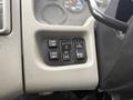 Interior dashboard controls of a 2013 International Workstar 7500 including buttons for mirror settings light controls and panel options